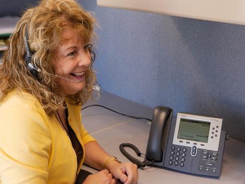 woman with headset talking on phone