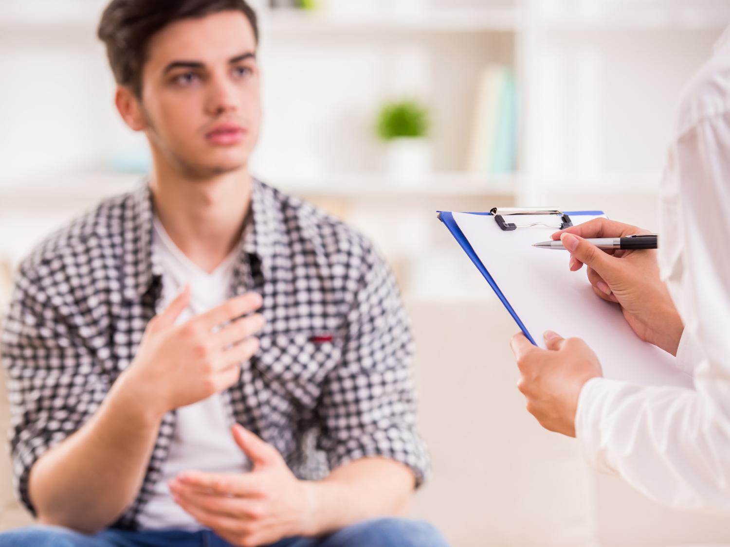 A counselor talks with a distressed patient.