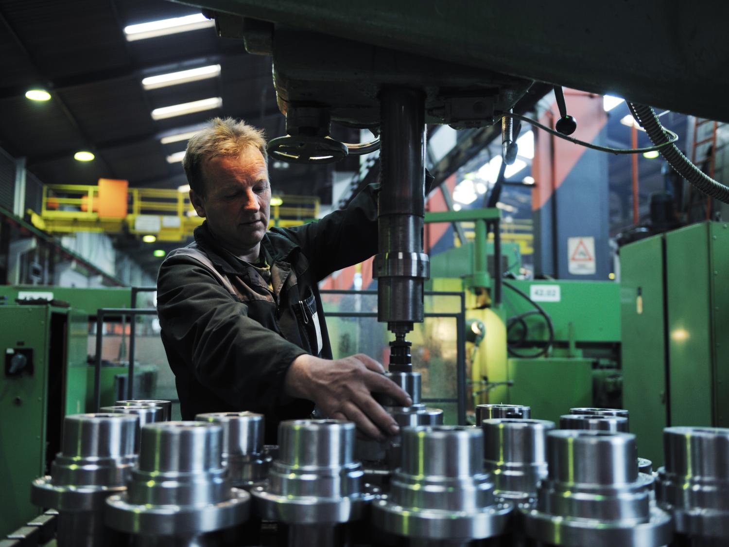 A man operates equipment in an advanced manufacturing environment.