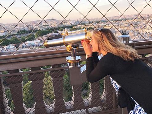 Michaella Caruso looking through a telescope in Paris