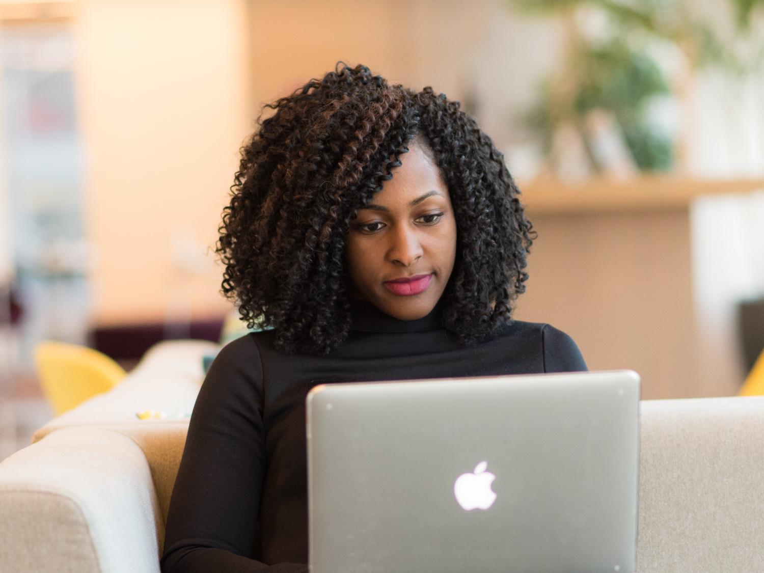 woman sitting looking at laptop