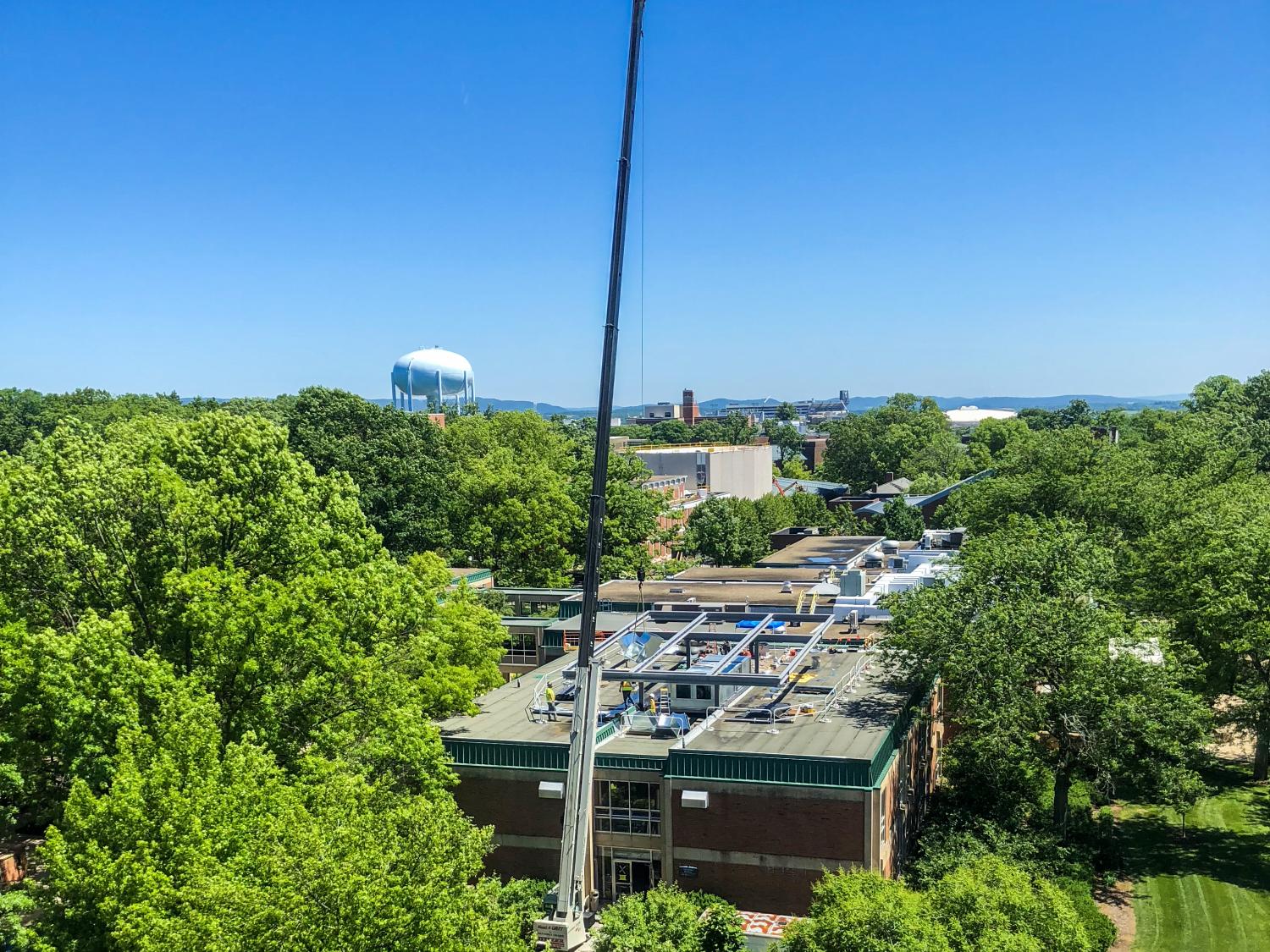 Crane lifting materials onto the roof of Chambers Building