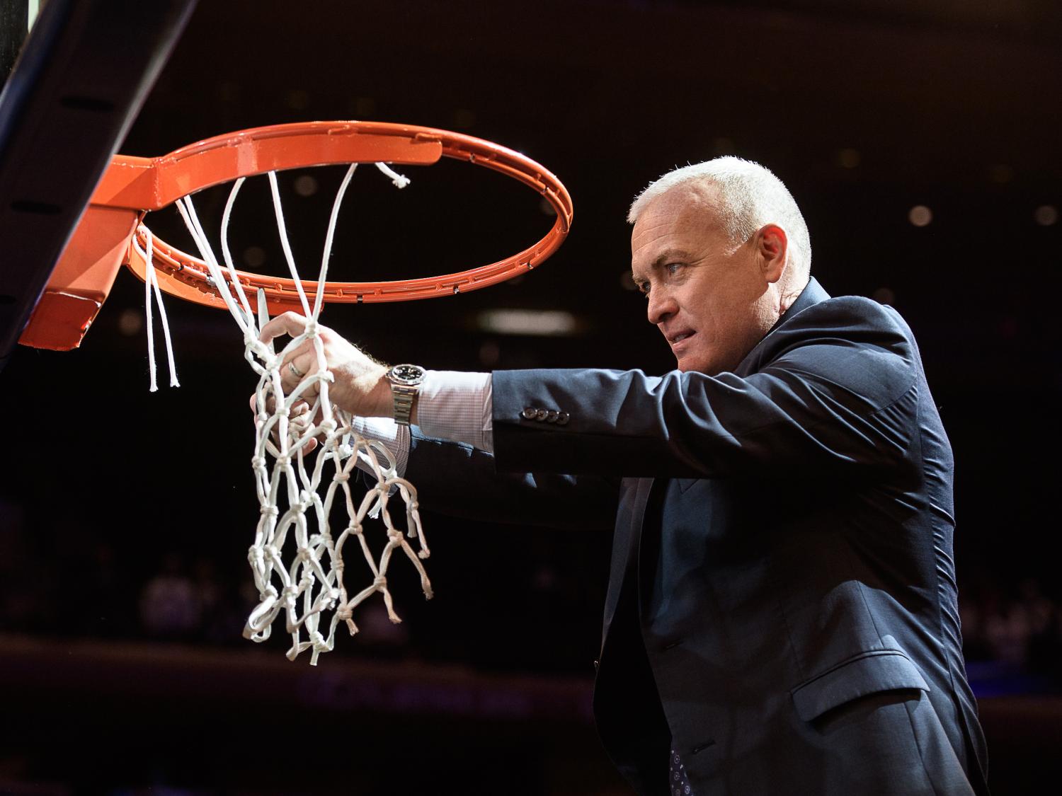 Penn State men's basketball coach Patrick Chambers cuts down the net after winning the 2018 National Invitation Tournament title 