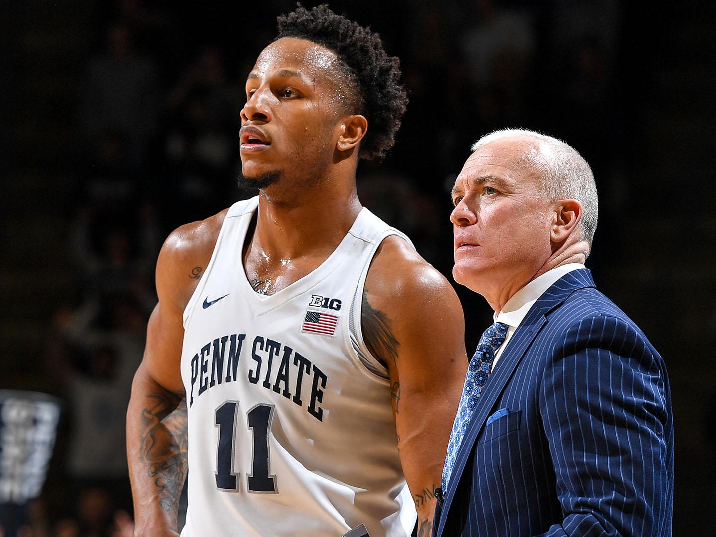 man in basketball uniform next to man in suit