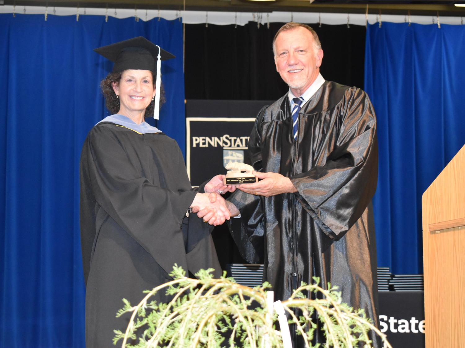Assistant Teaching Professor LuAnn Demi receives her DEF Educator of the Year Award from DEF president Craig Ball
