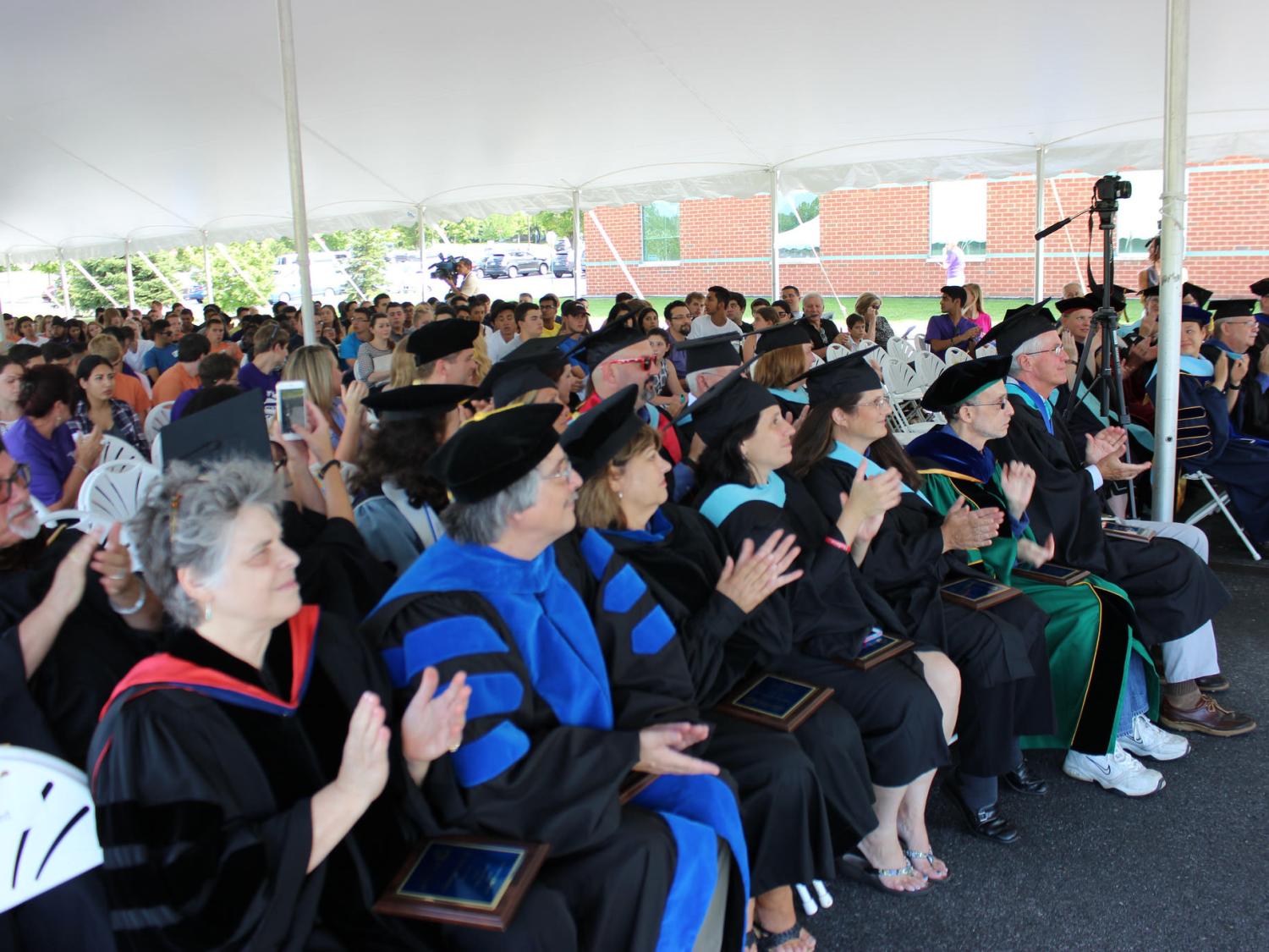 Group of faculty clap at convocation