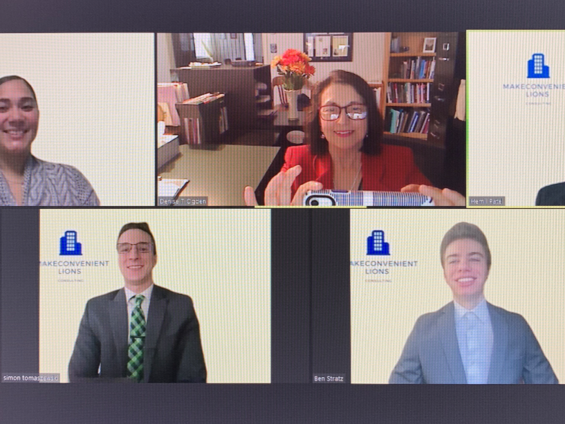 zoom photo of four team members and a professor