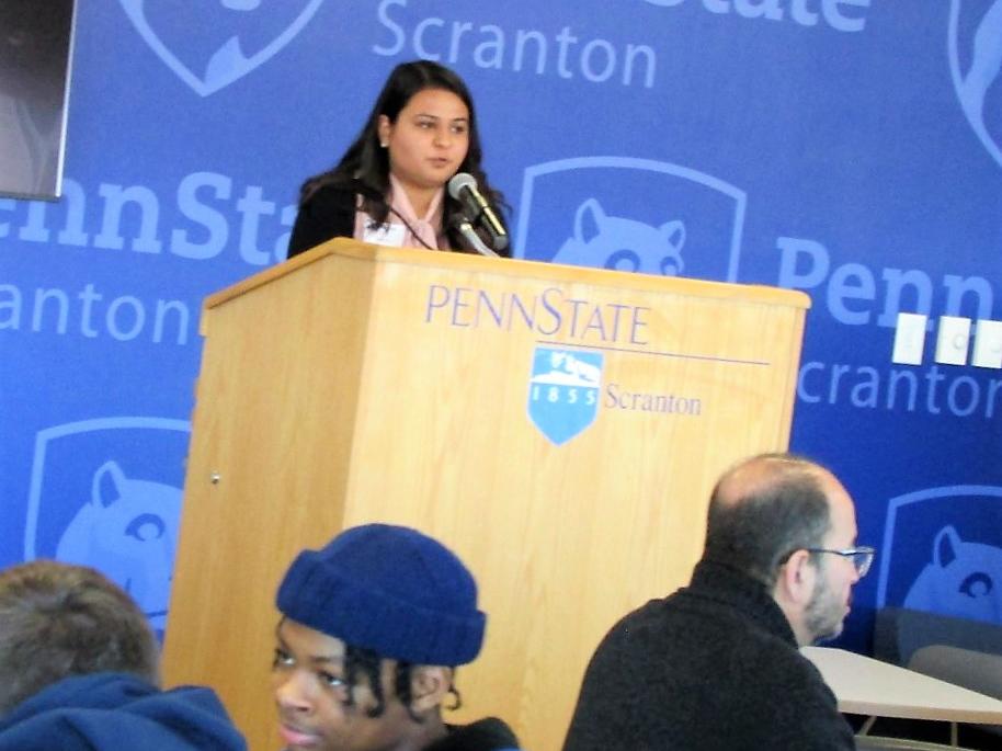 Dharti Ray at the podium welcoming visitors to the MLK event