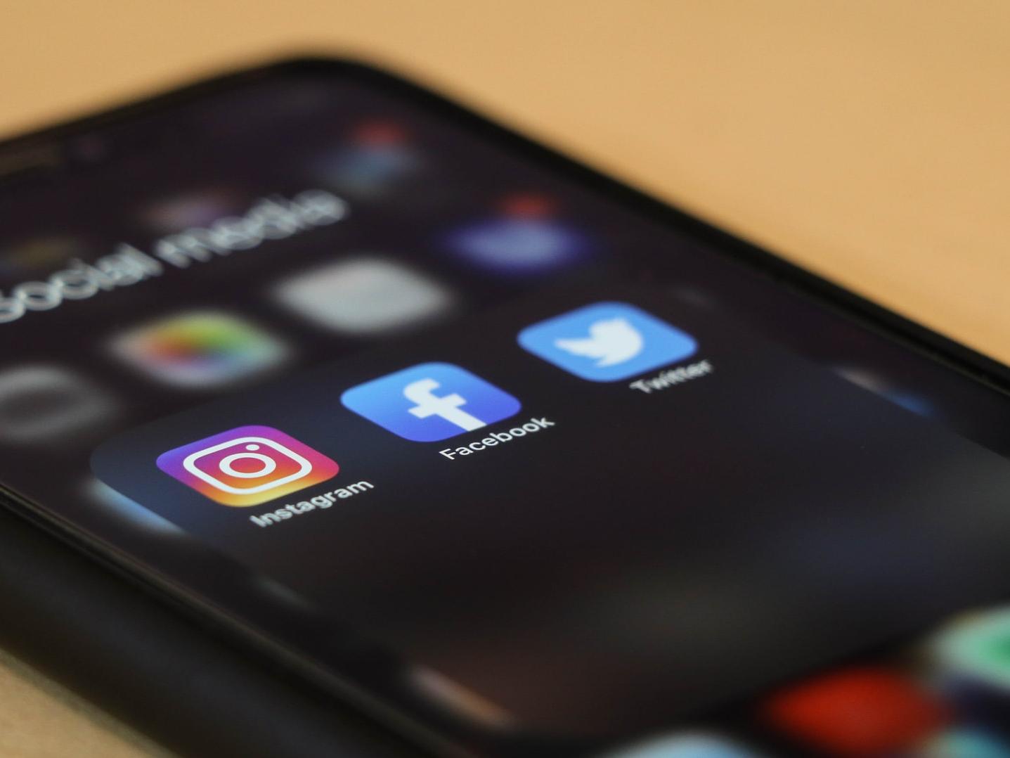 Close up of smartphone screen with social media icons in focus