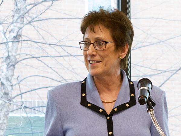 Former DAA and interim chancellor Donna Kuga speaks at a podium.