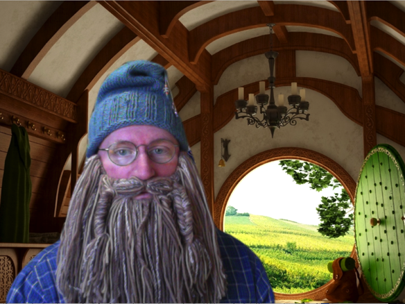 man dressed as Gandalf from The Hobbit movie standing in front of Hobbit-themed virtual background
