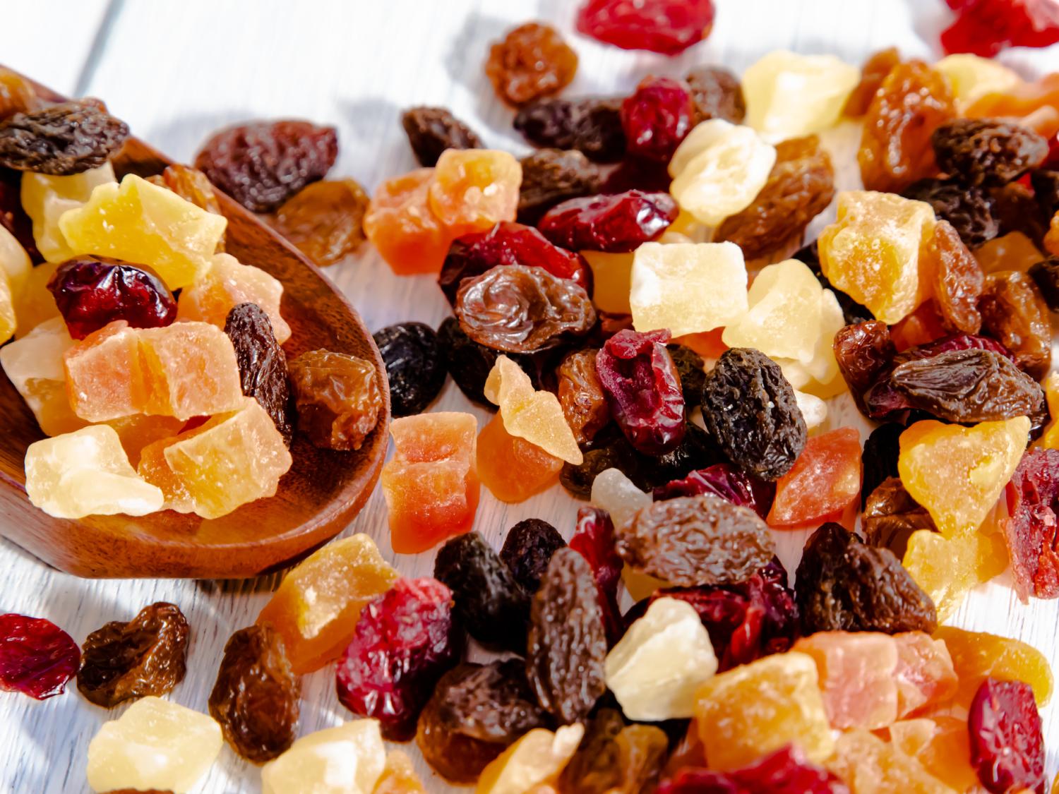 A variety of dried fruit mix spilled on a table