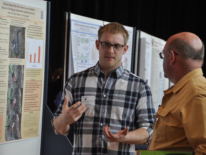 Student explaining poster