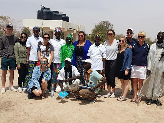 Engineering Leadership Development students pose for a photo with Senegalese farmers. 