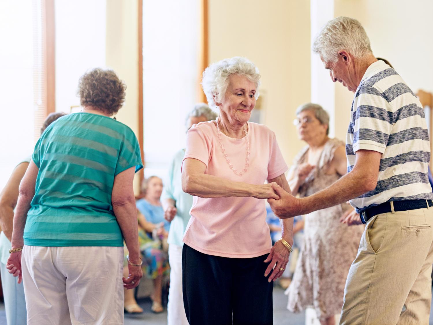 elderly men and women dancing