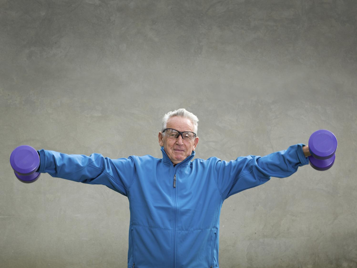 elderly man using barbells