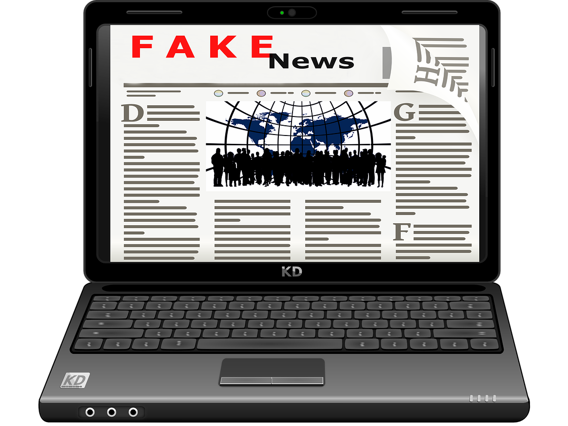 graphic of laptop showing screen mimicking a news article's text with words at top: "fake" in red, "news" in black