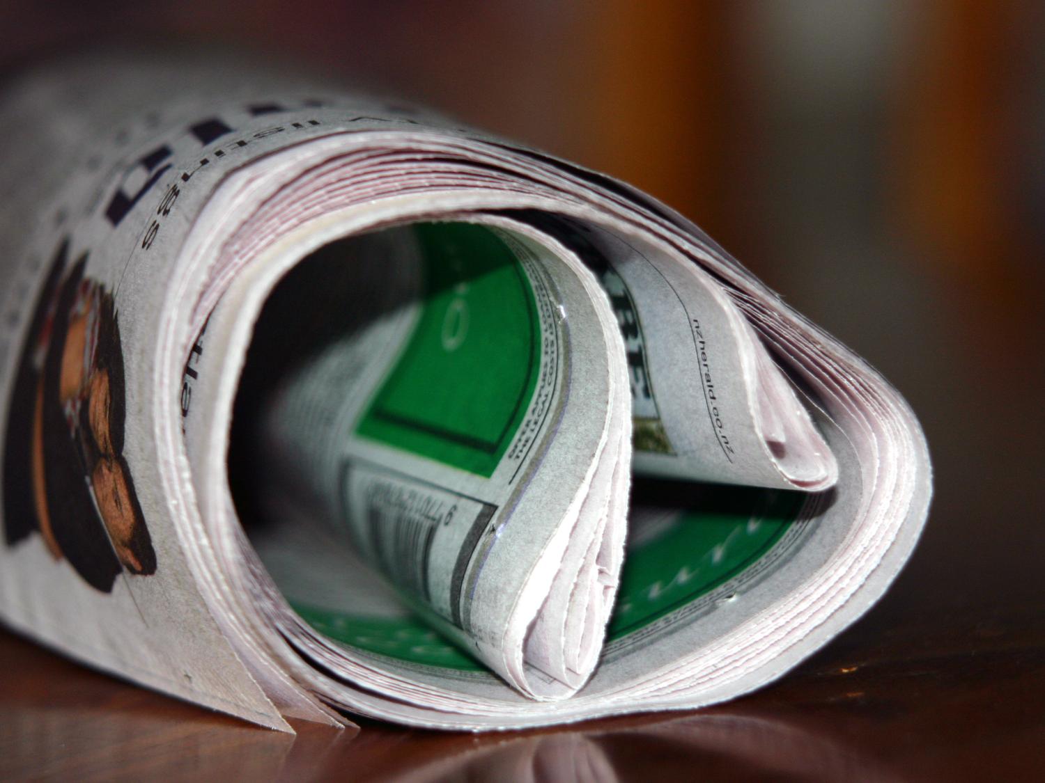 Newspaper rolled up.
