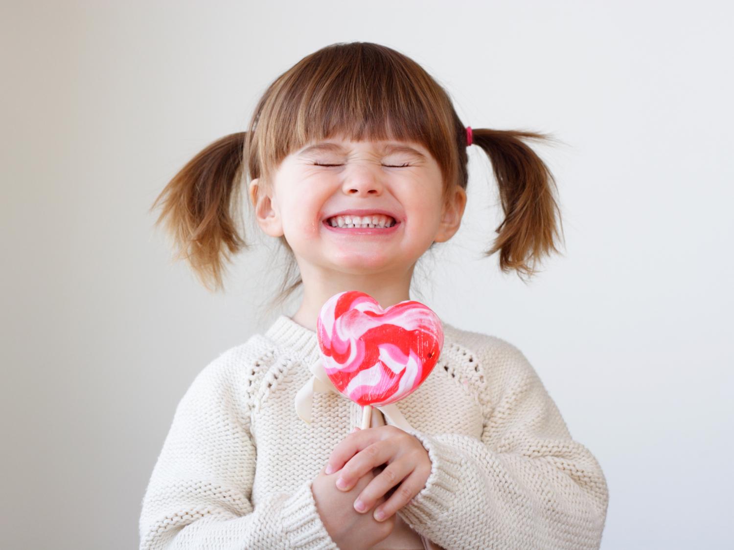 girl with heart-shaped lollipop