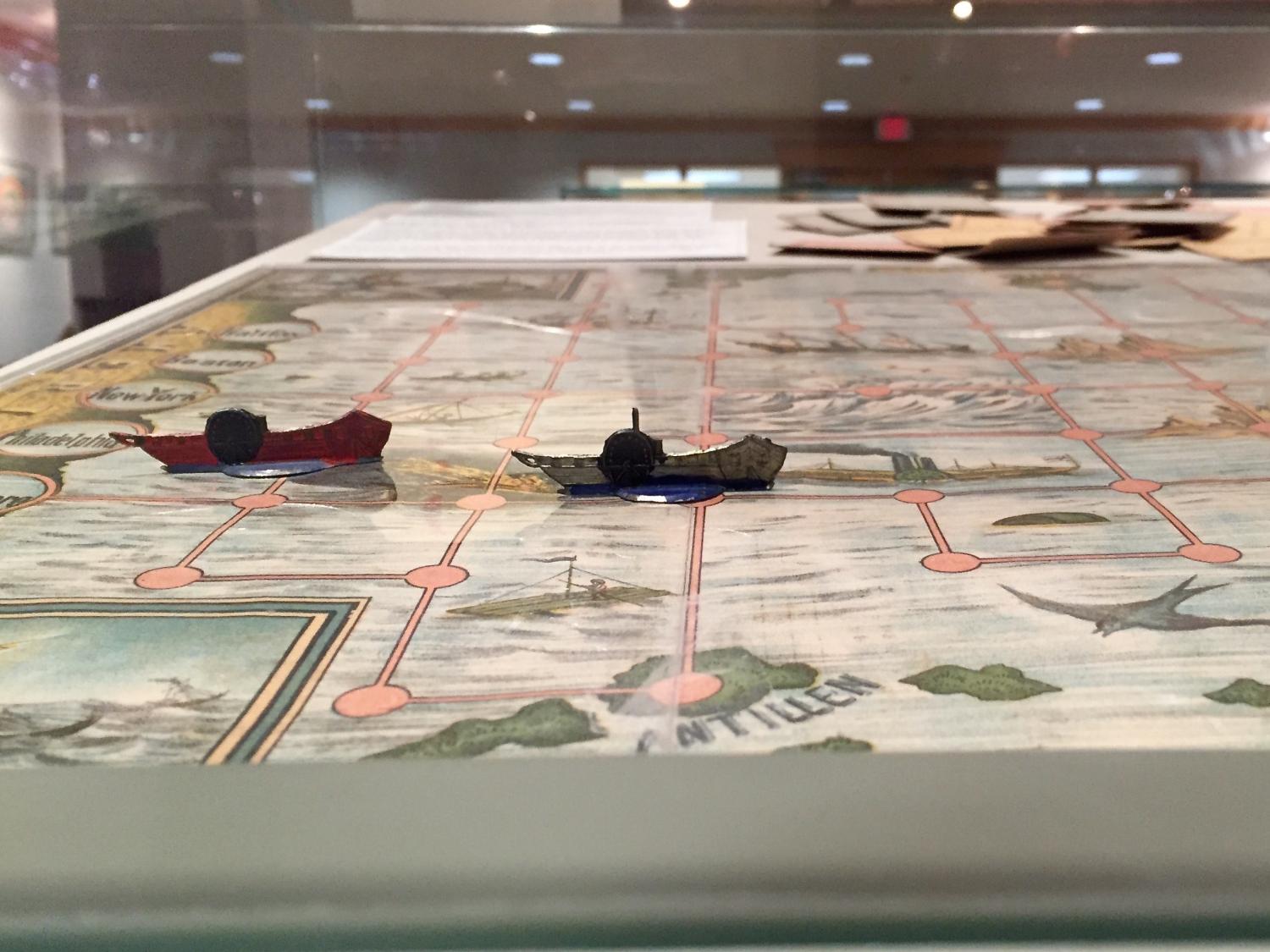 printed game board of map with ship game pieces from Special Collections Library exhibit