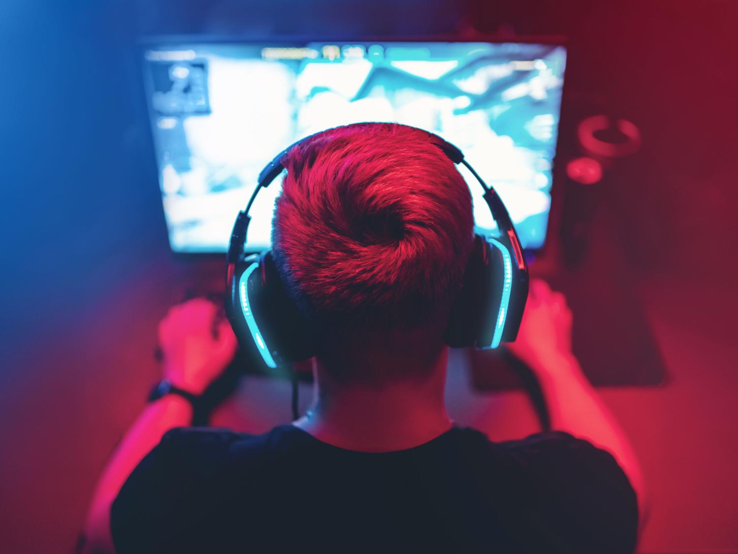 A young man plays an online game on the computer