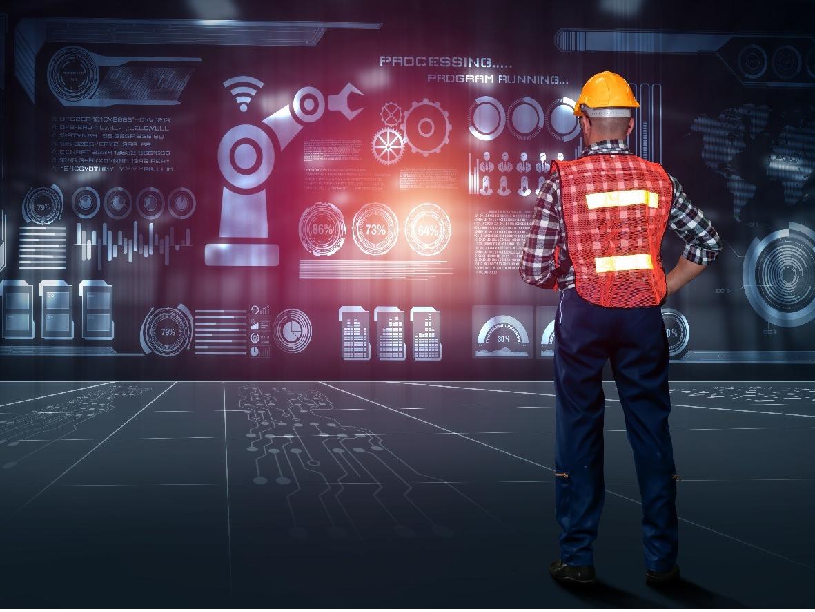 Construction worker looking at a wall of gears
