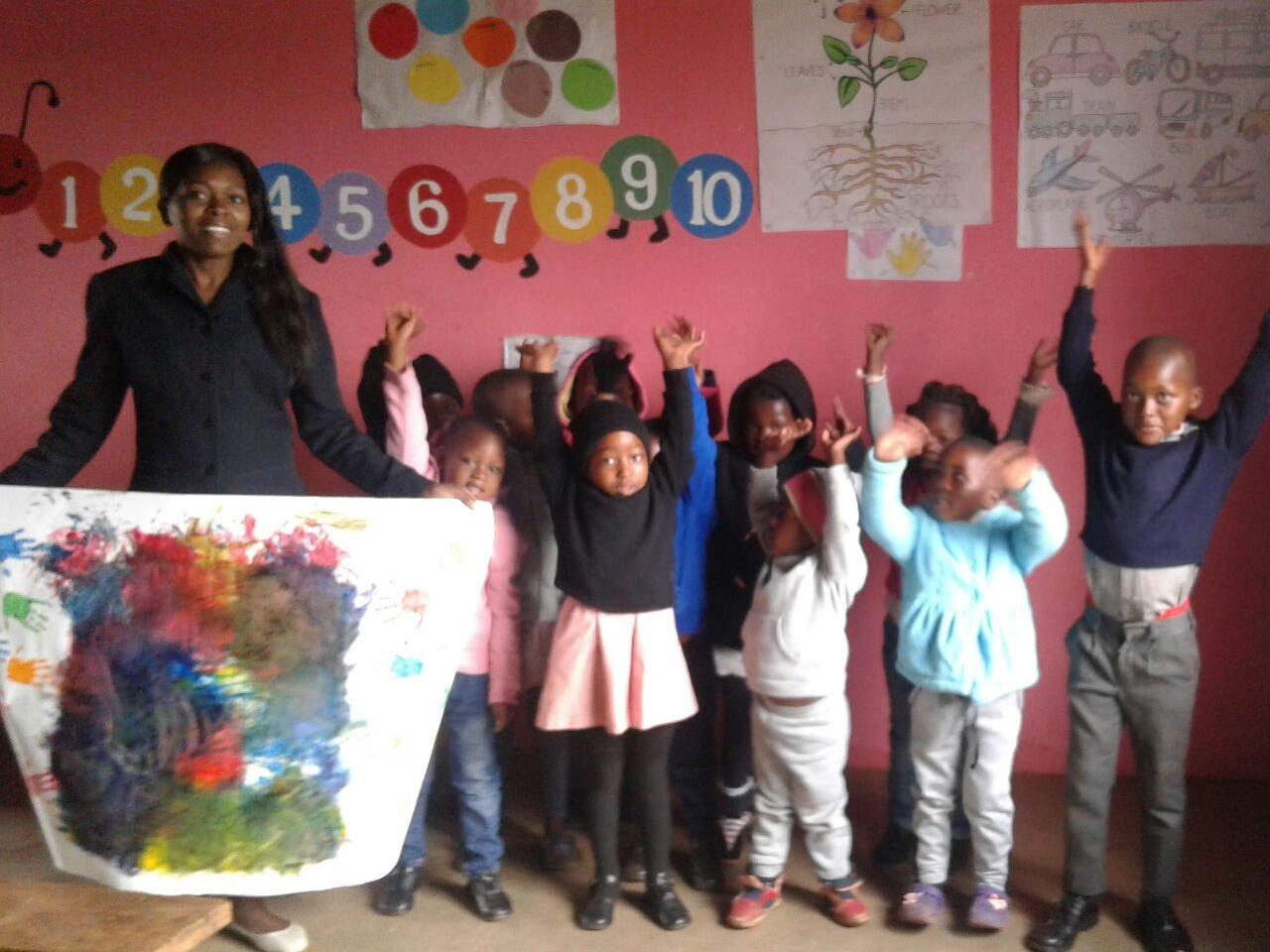 Preschool Children in Msengeni, Swaziland, Africa, photographed with the art work received from children at Penn State’s Child Care Center at Hort Woods.