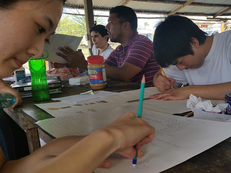 Eighteen Penn State students traveled to Panama to help local business owners sharpen their business skills and improve their financial literacy. Here, students Michael Wu and Hui Li develop inventory lists for the owner of a kiosk in Panama.