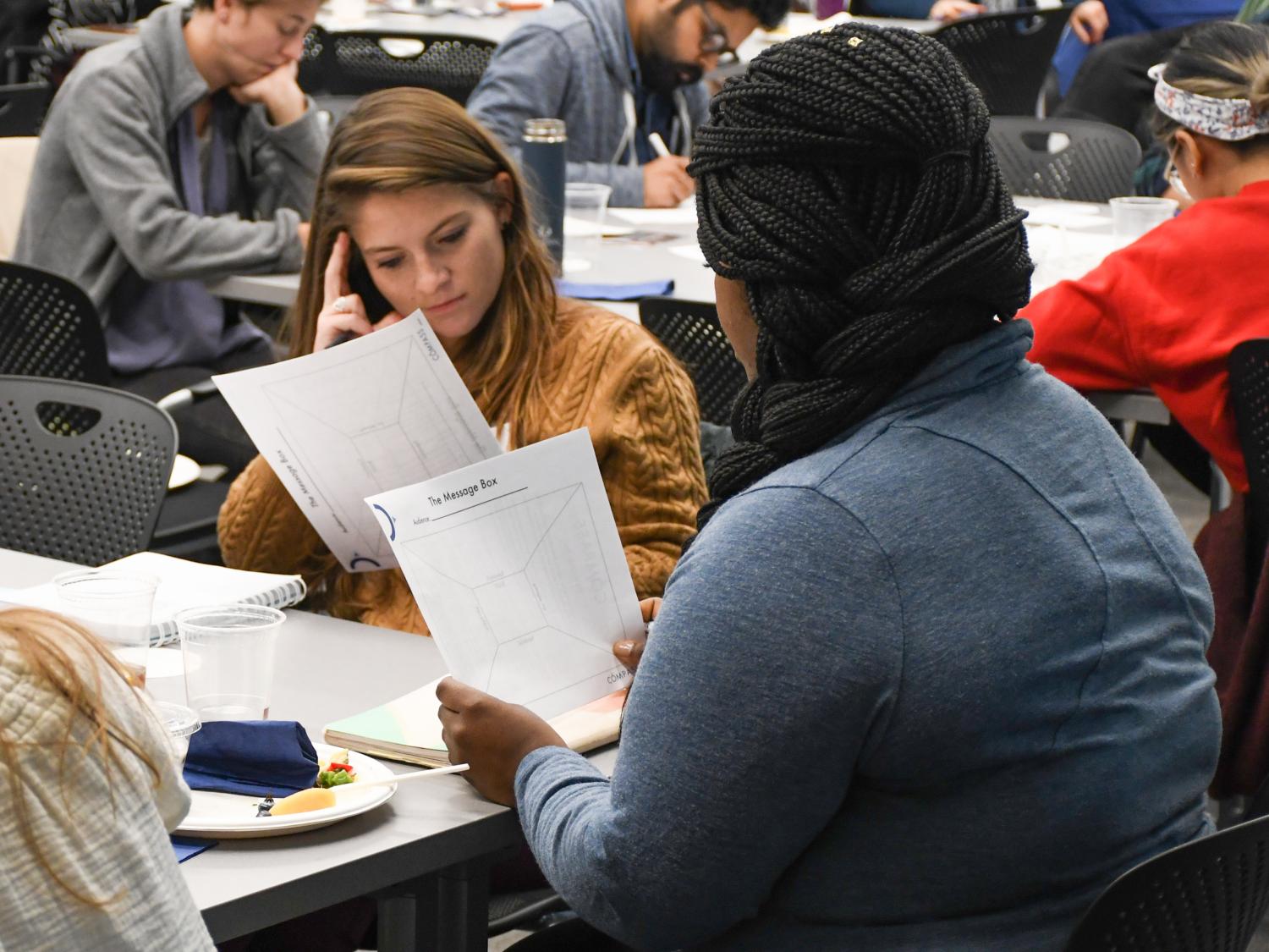 Graduate students review their message box tool during a science communication workshop in 2019.