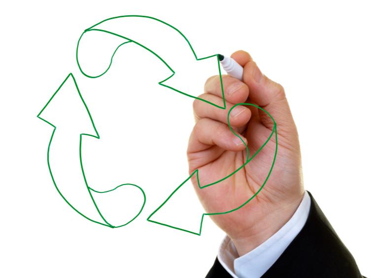 man's hand drawing recucle symbol