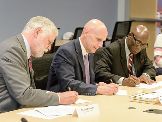 Drs. Chown, Sygielski, and Achampong sign articulation agreements.