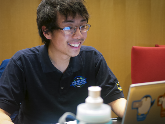 Stanley Chan works at a laptop during HackPSU
