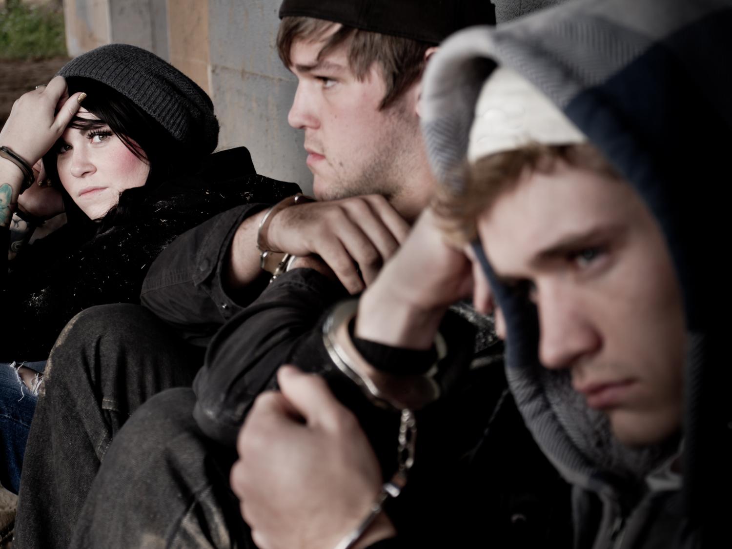 three teens in handcuffs