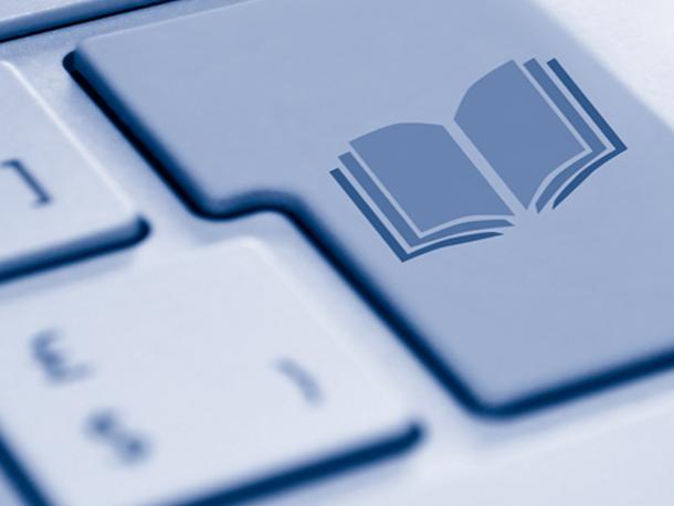 closeup of keyboard with open book graphic on enter key