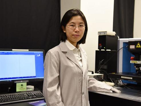 A professor stands in a laboratory 