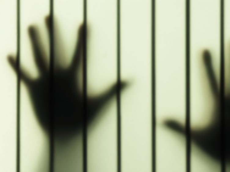translucent glass with bars and shadow hands