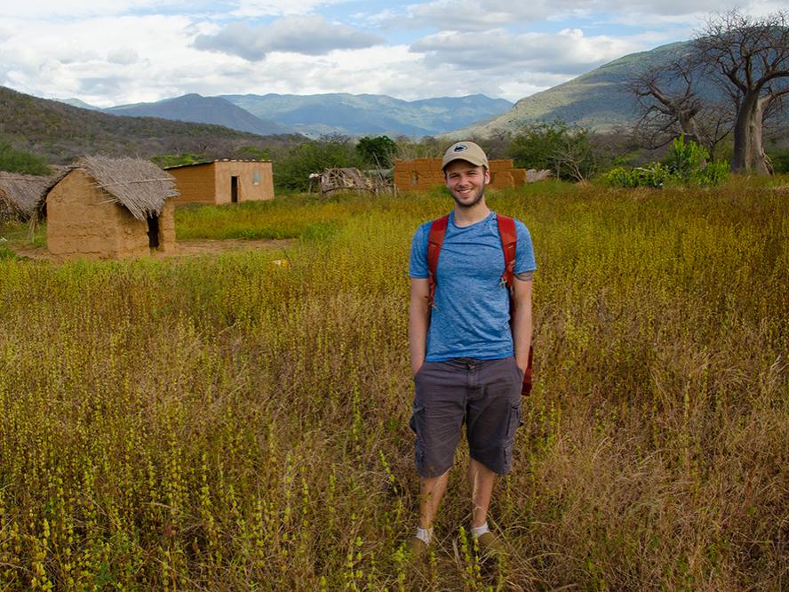 student standing in field in Tanzania