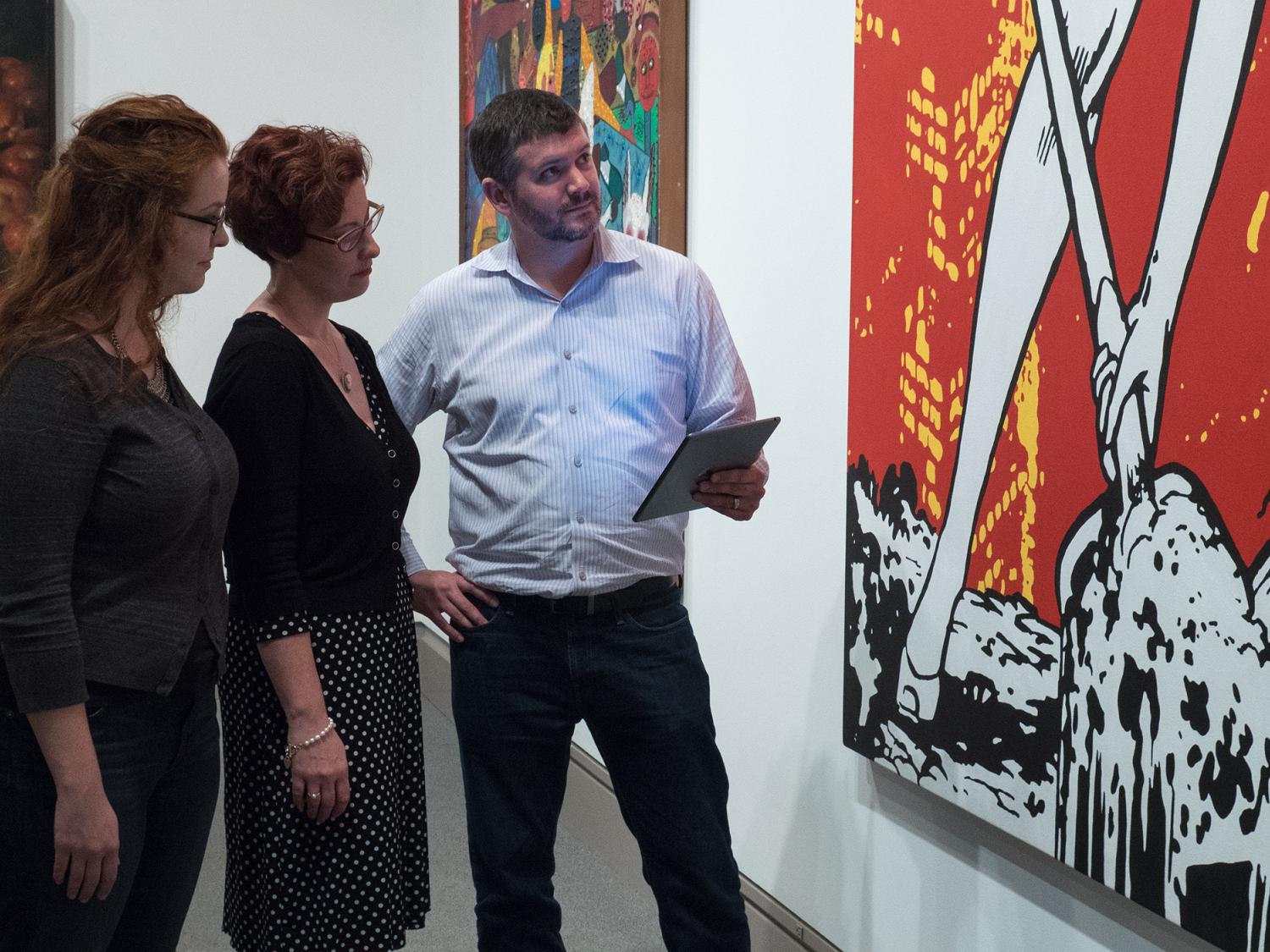 The iBeacons team views a painting