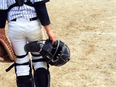 back of a baseball catcher walking