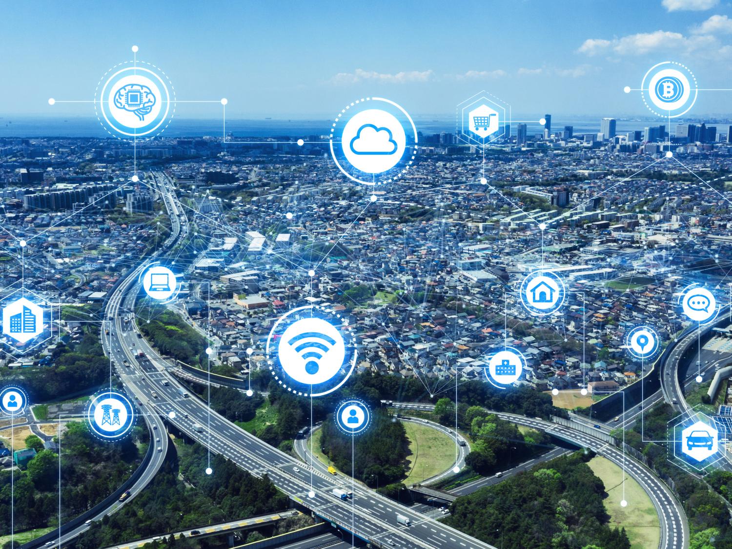 An illustration depicts various communication and home living icons overlaid on an aerial photo of a city.