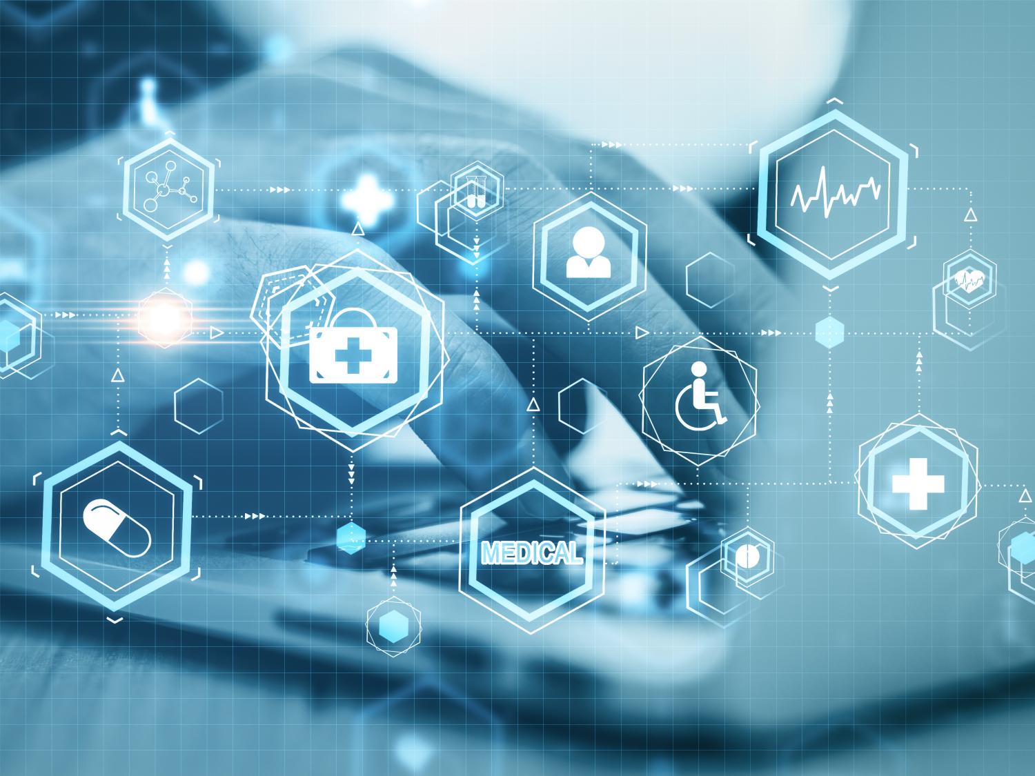 a hand on a laptop keyboard overlaid with medical icons