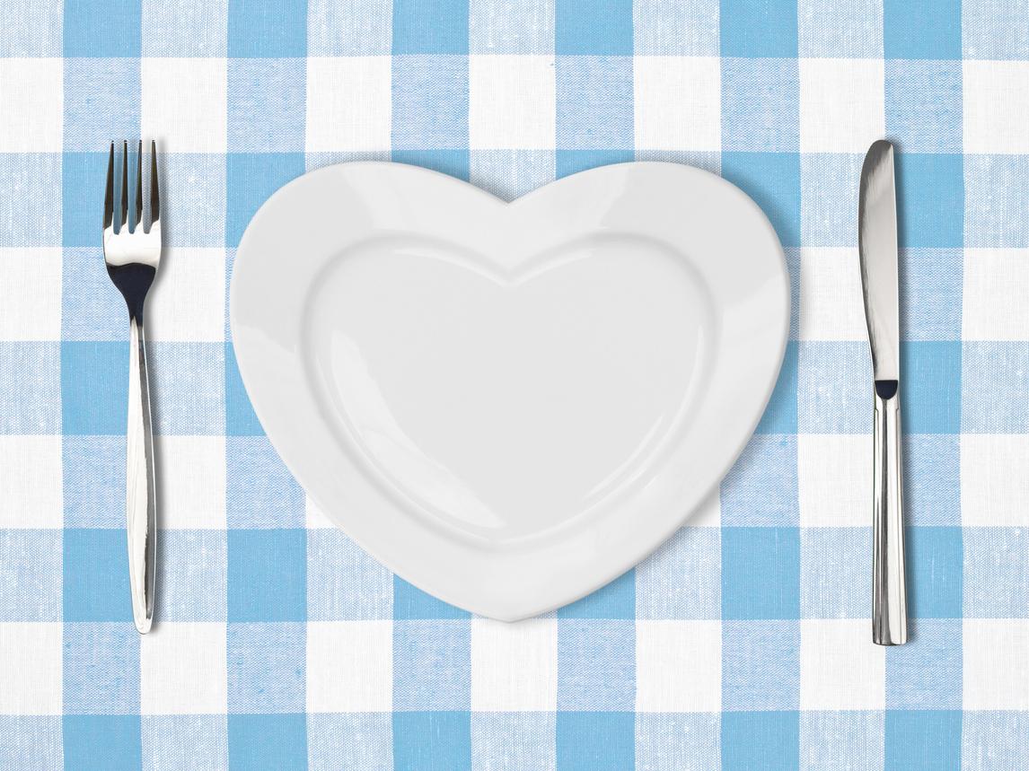 A heart-shaped plate with a fork and knife.