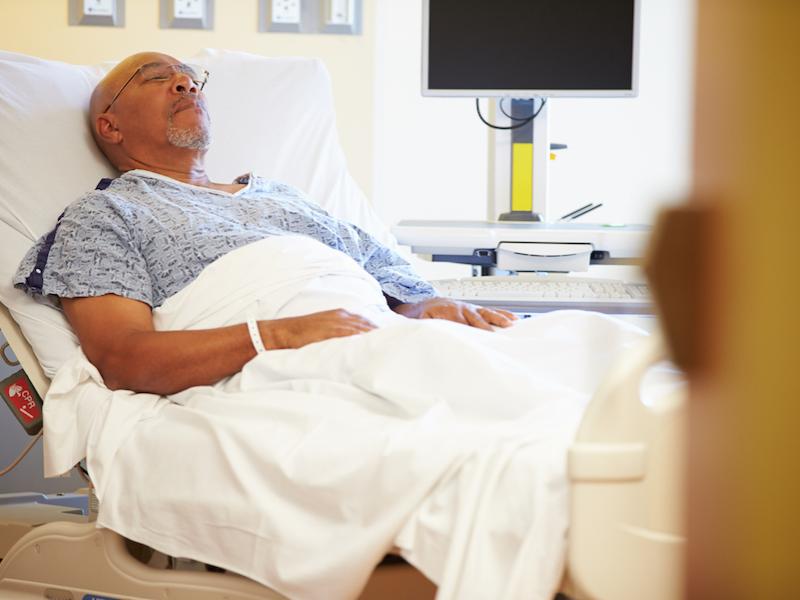Senior Male Patient Resting In Hospital Bed