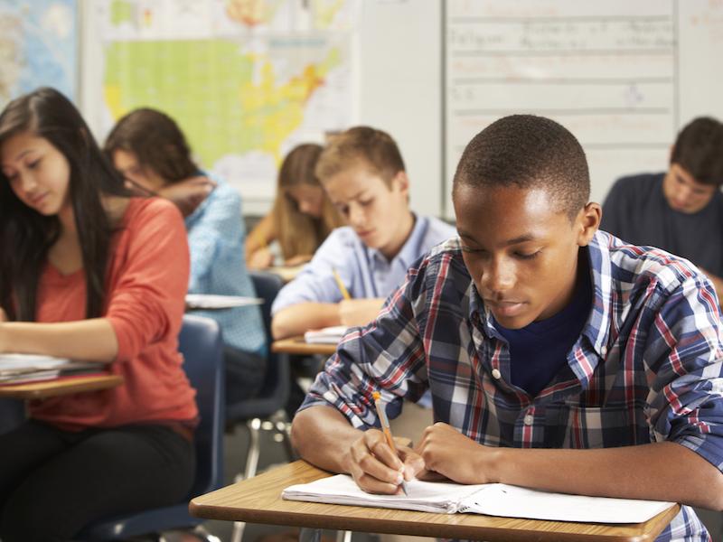 Students classroom writing in notebooks