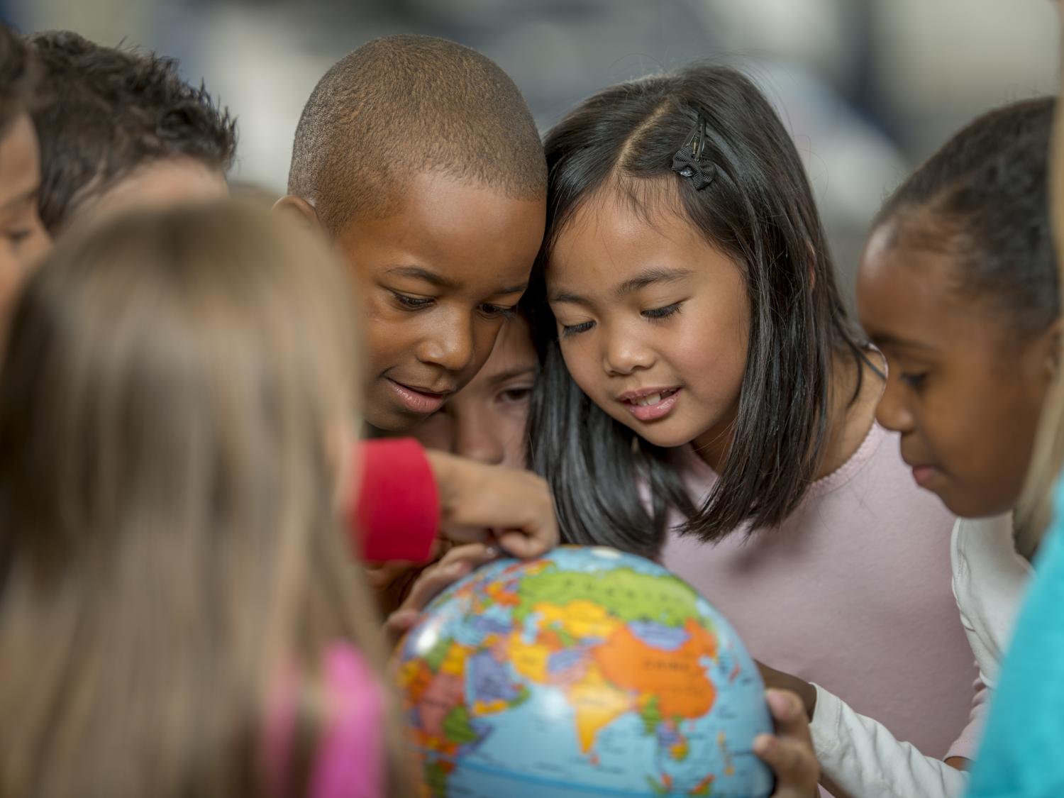 Children looking at a globe