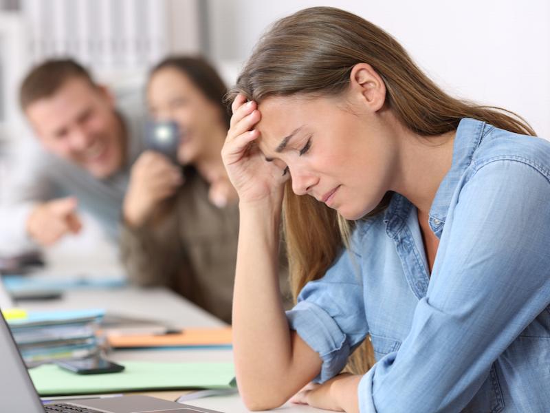 Cyber bullying victim being photographed at office