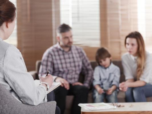 Family sitting on a sofa in the blurred background