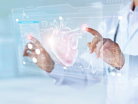 doctor in lab coat looks at a floating image of a human heart
