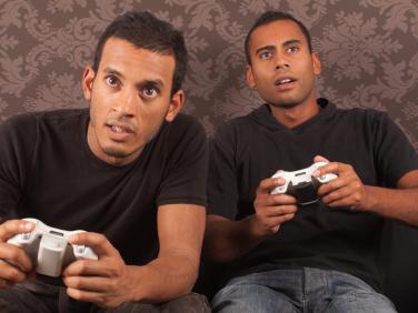 2 young men with game controllers