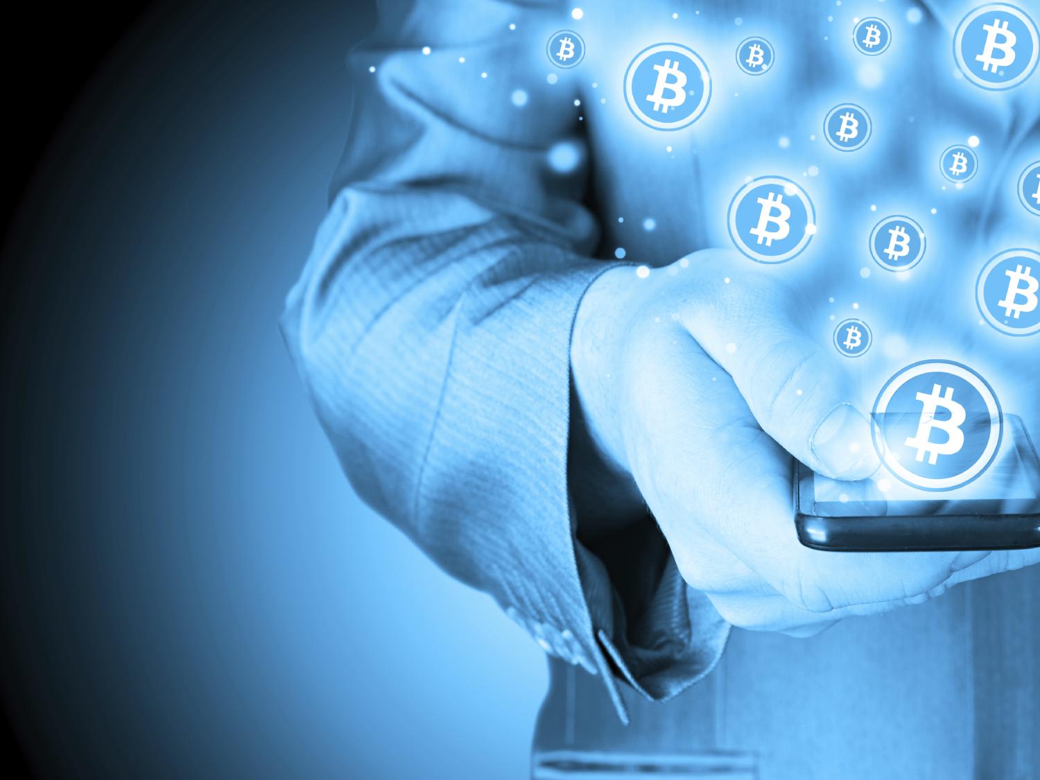 photo illustration with smartphone and bitcoins